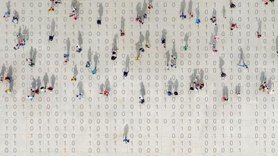 People walk atop binary code